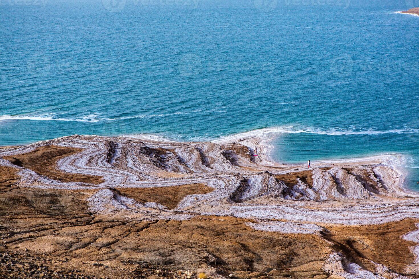 View of Dead Sea coastline at sunset time in Jordan. Salt crystals at sunset. Dead sea landscape with mineral structures. photo