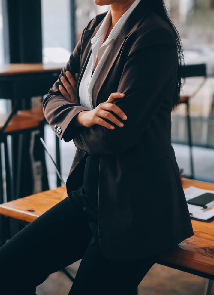 Asian Businesswoman working on laptop at the office with documents on his desk, doing planning analyzing the financial report, business plan investment, finance analysis concept photo
