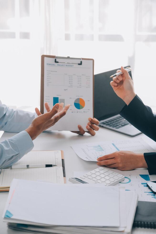 Business team working with new startup project plan and discussion information for financial strategy with laptop and digital tablet in a modern business lounge. photo