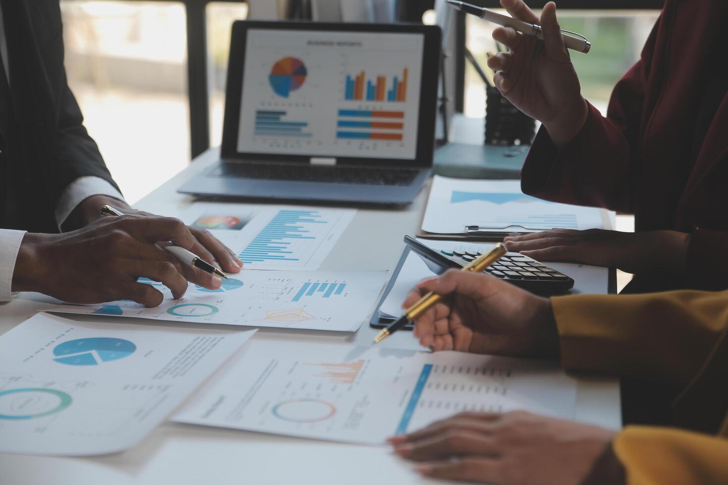 Financial analysts analyze business financial reports on a digital tablet planning investment project during a discussion at a meeting of corporate showing the results of their successful teamwork. photo