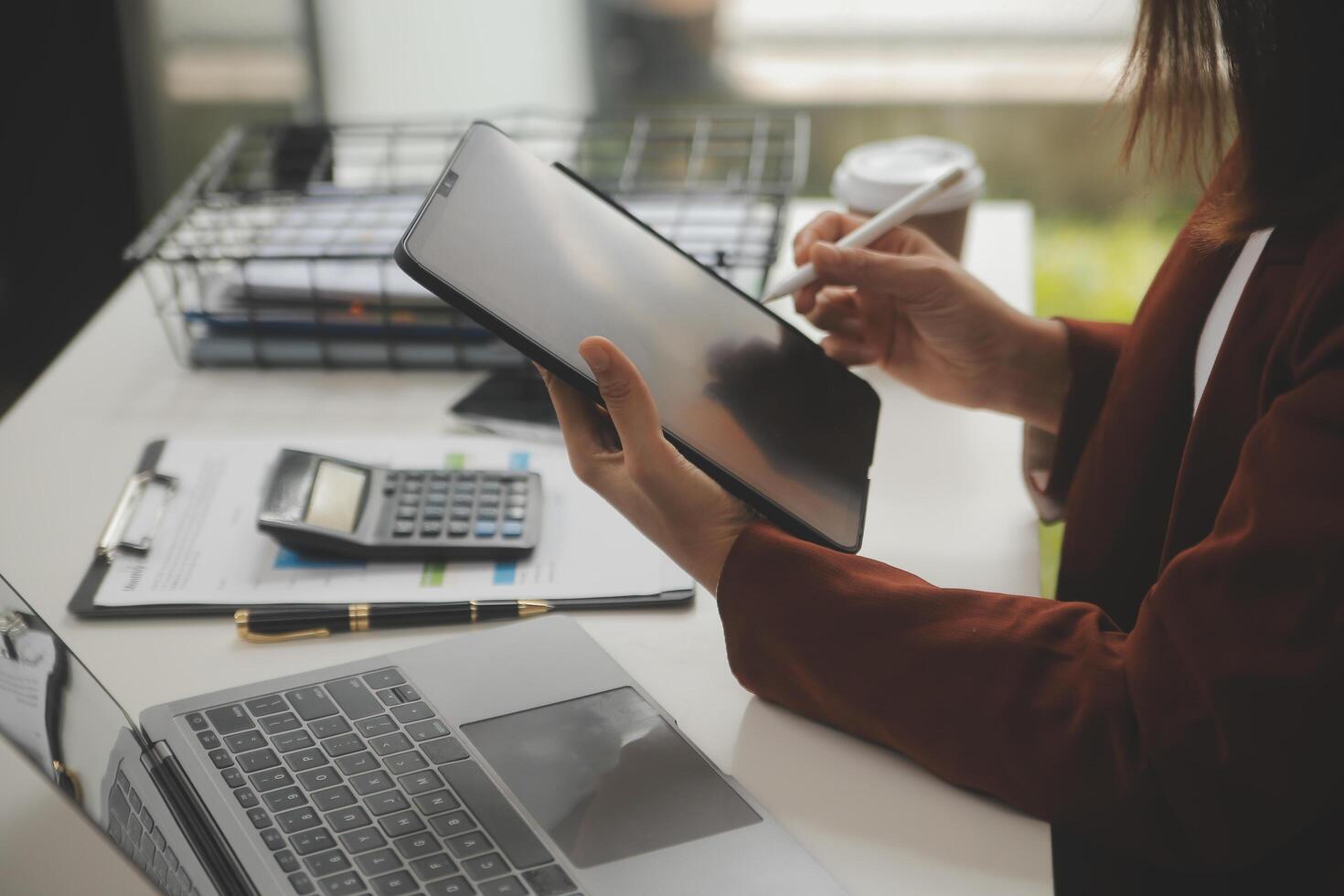 Shot of a asian young business Female working on laptop in her workstation. photo