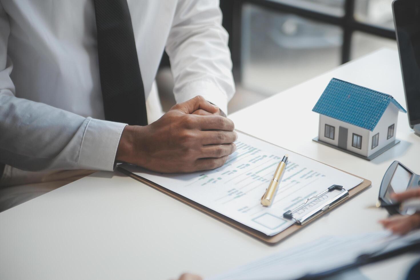 Real estate agent and customer signing contract to buy house, insurance or loan real estate.rent a house,get insurance or loan real estate or property. photo