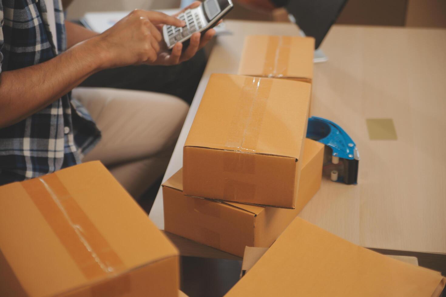 Two Asian blogger showing clothes in front of the camera to recording vlog video live streaming at her shop. Online Shopping Cart notion. on sofa at home photo