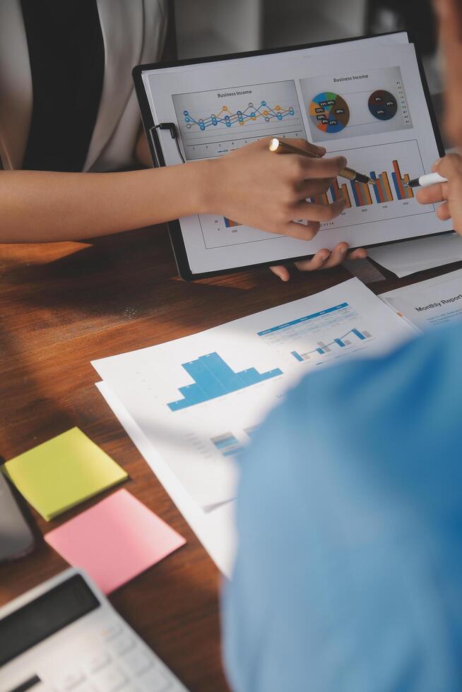Close up of Business team analyzing income charts and graphs with modern laptop computer. Business analysis and strategy concept. photo
