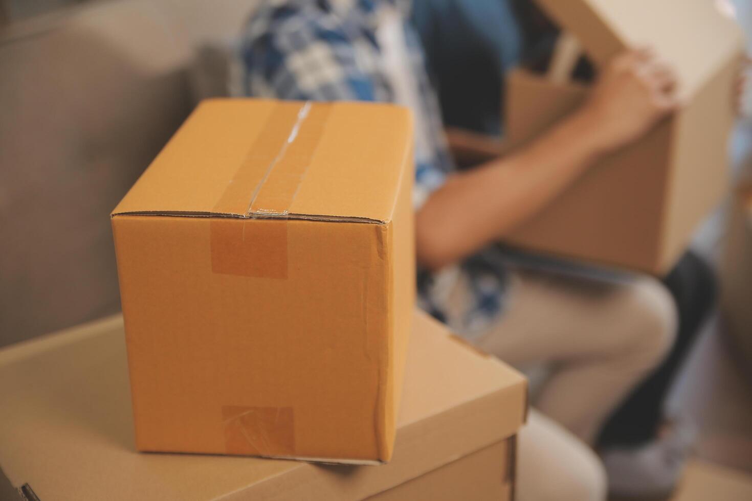 Two Asian blogger showing clothes in front of the camera to recording vlog video live streaming at her shop. Online Shopping Cart notion. on sofa at home photo