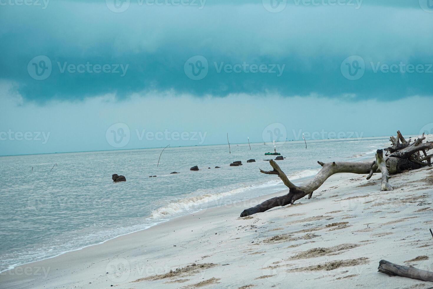 View of a white sand beach with cloudy weather and skies photo