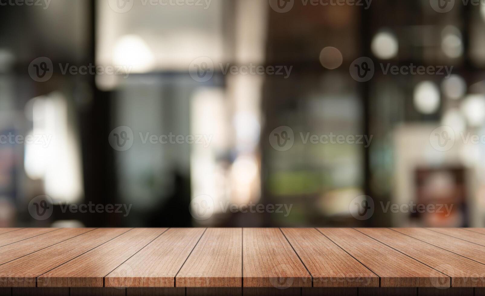 Empty wooden table top with lights bokeh on blur restaurant background. photo