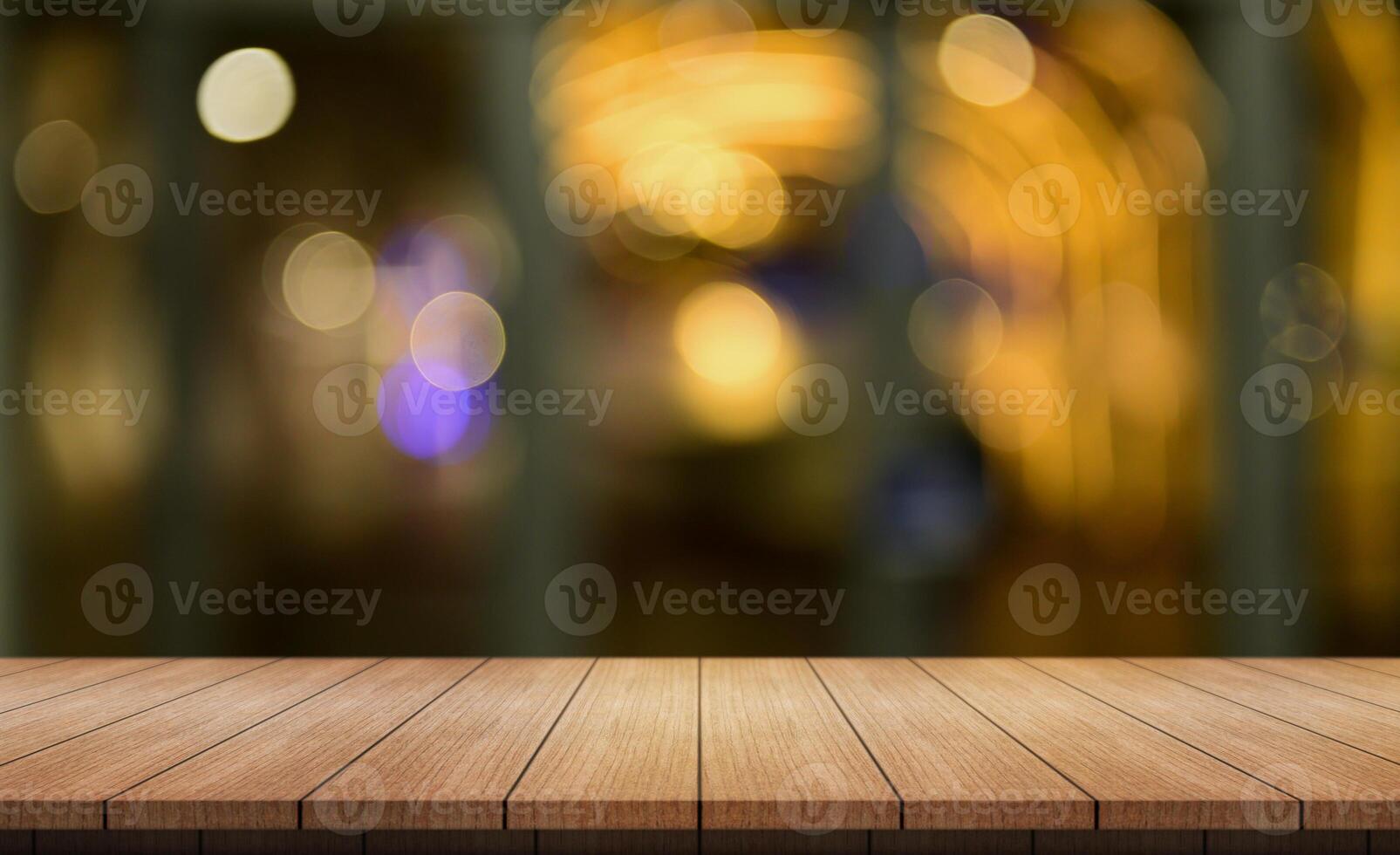 Empty wooden table top with lights bokeh on blur restaurant background. photo