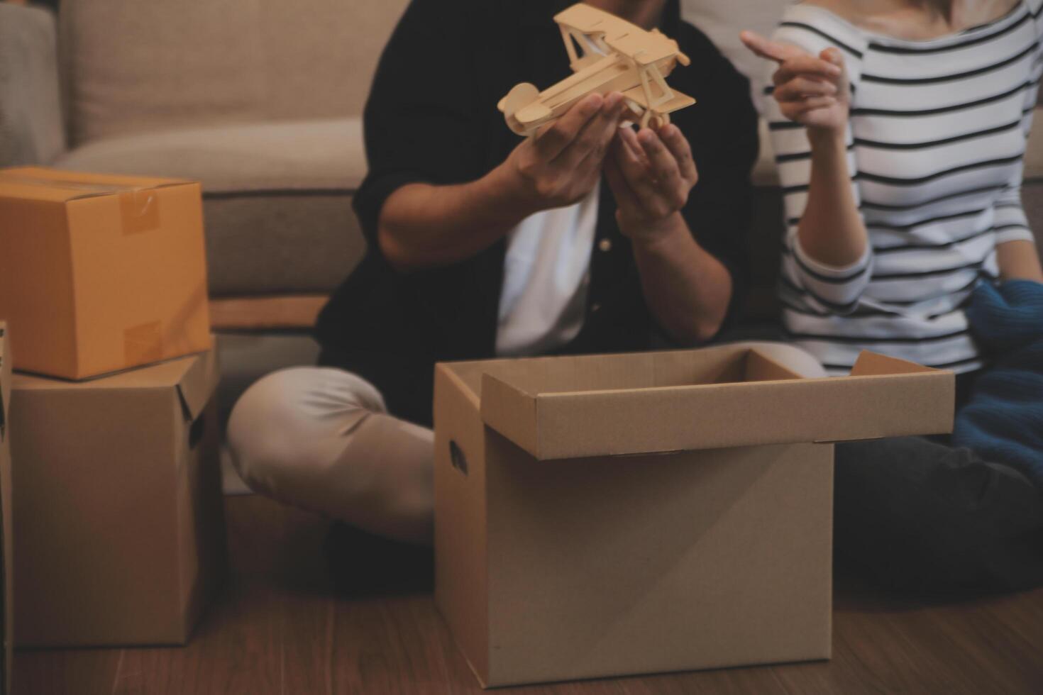 Two Asian blogger showing clothes in front of the camera to recording vlog video live streaming at her shop. Online Shopping Cart notion. on sofa at home photo