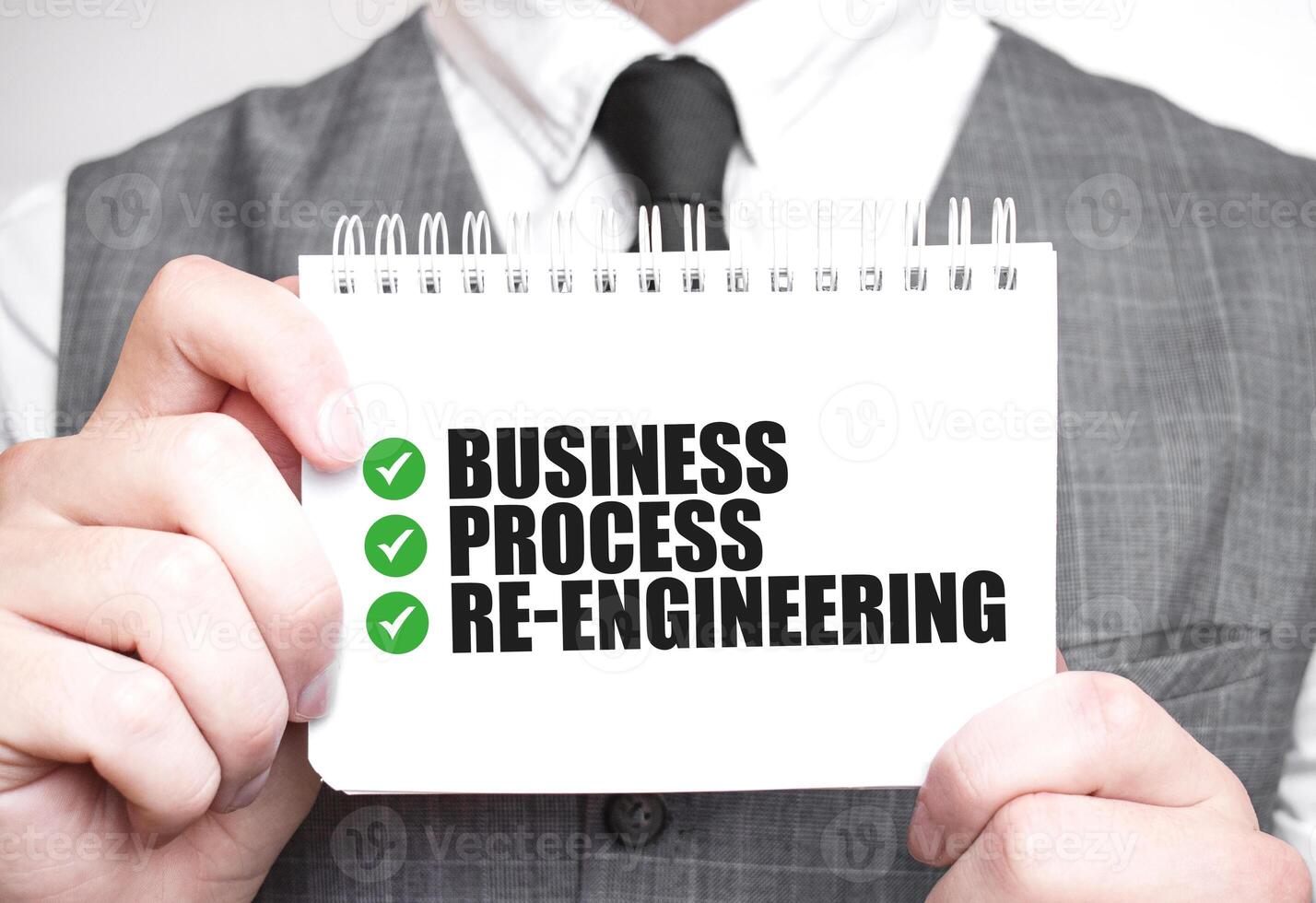 Businessman with notebook with text BUSINESS PROCESS RE ENGINEEERING photo