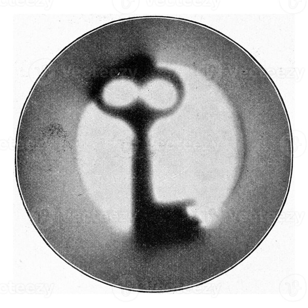 Photograph of a key with radium rays, vintage engraving. photo