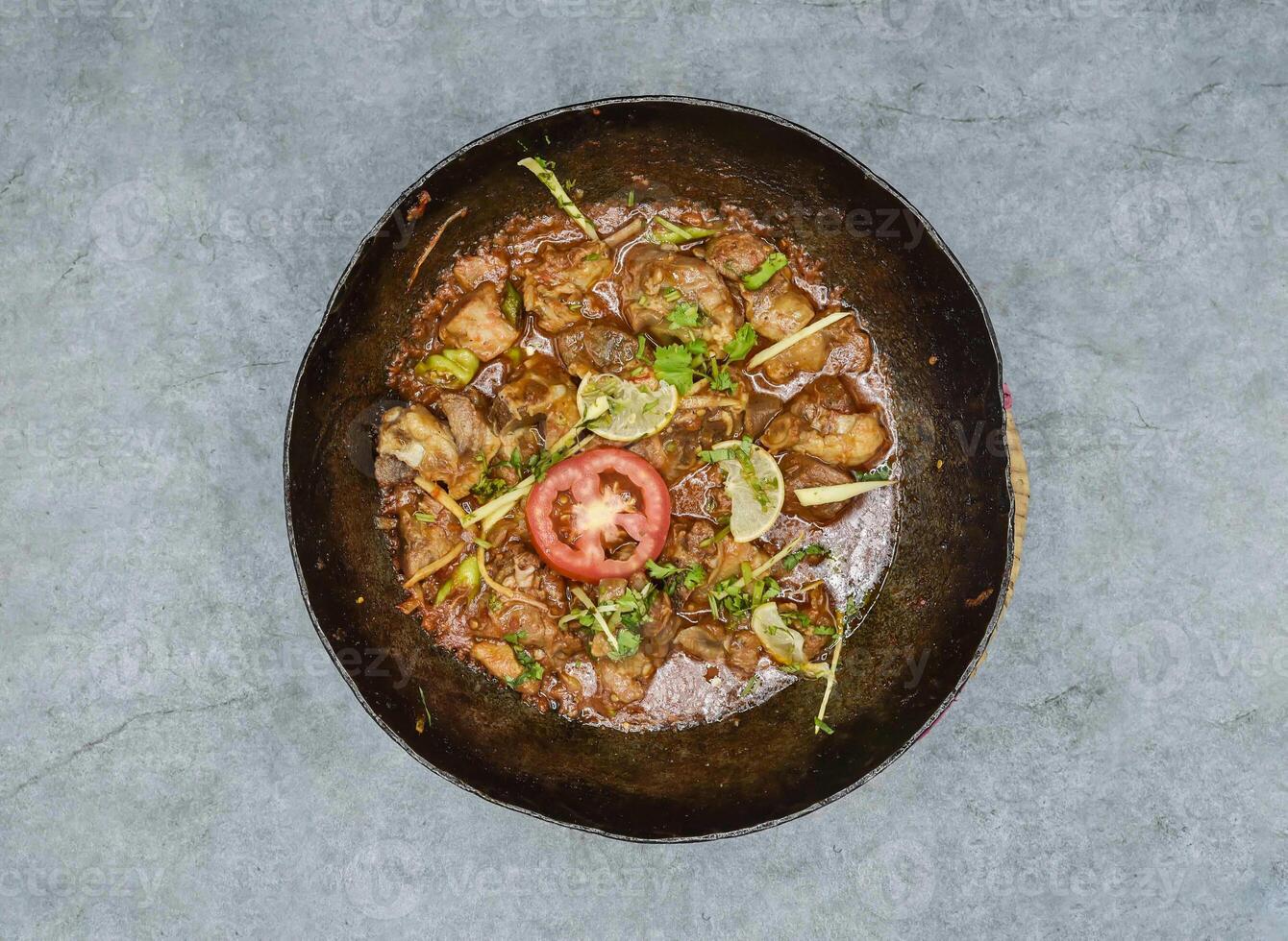Lamb or dumba karhai korma masala with gravy served in dish isolated on background top view of indian spices and pakistani food photo