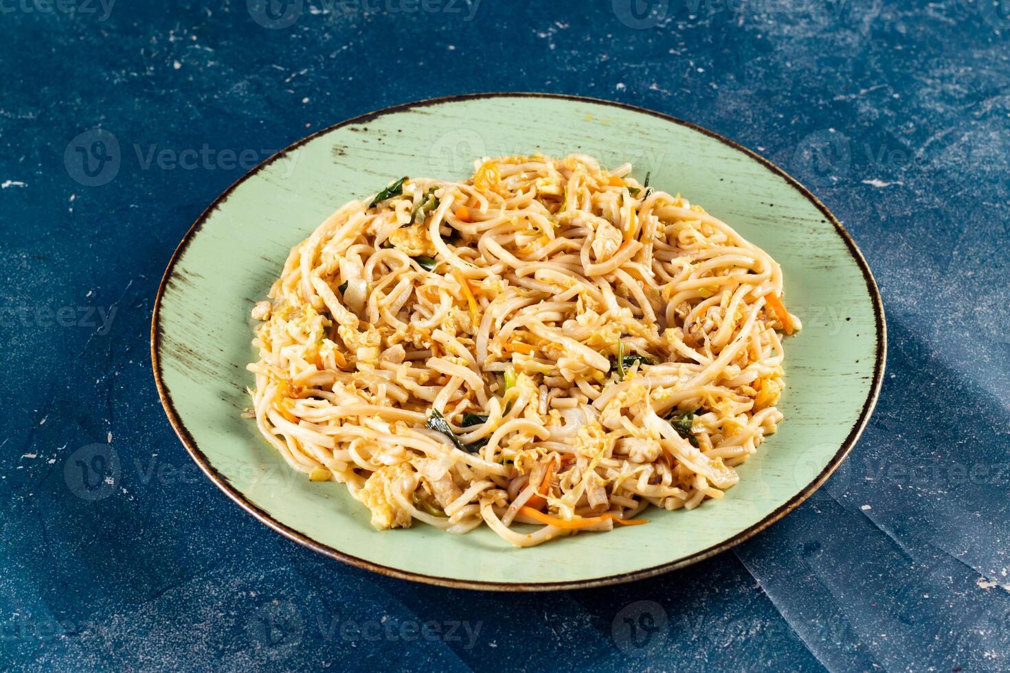 Traditional Spicy chow mein in a bowl isolated on marble background top view of chinese noodles photo