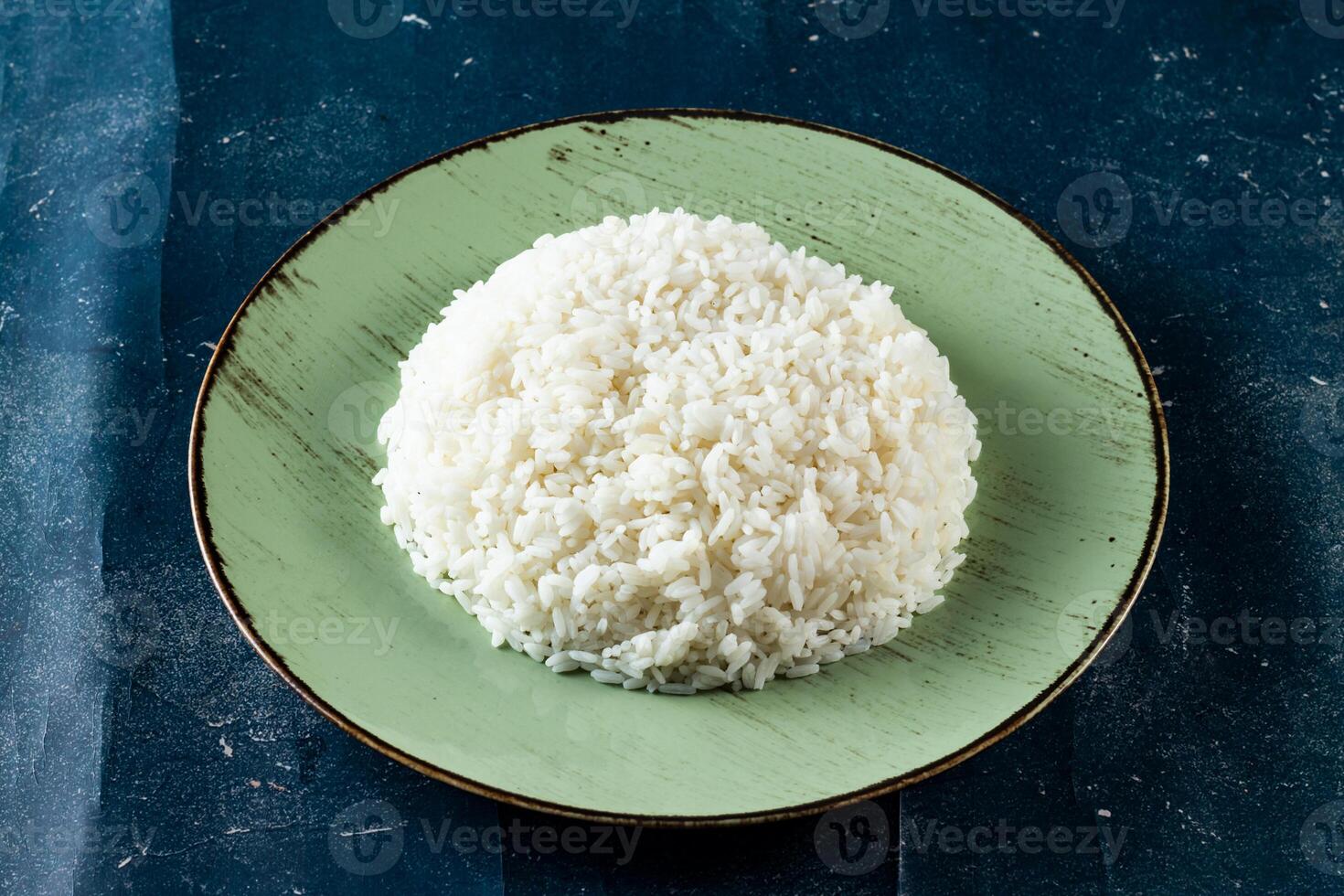 Plain boiled rice in a plate top view on marble background photo