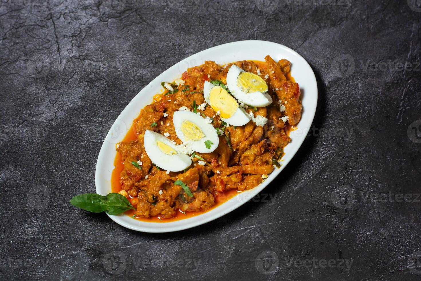 Chicken Bharta with boiled egg served in dish isolated on grey background top view of indian and bangladesh food photo