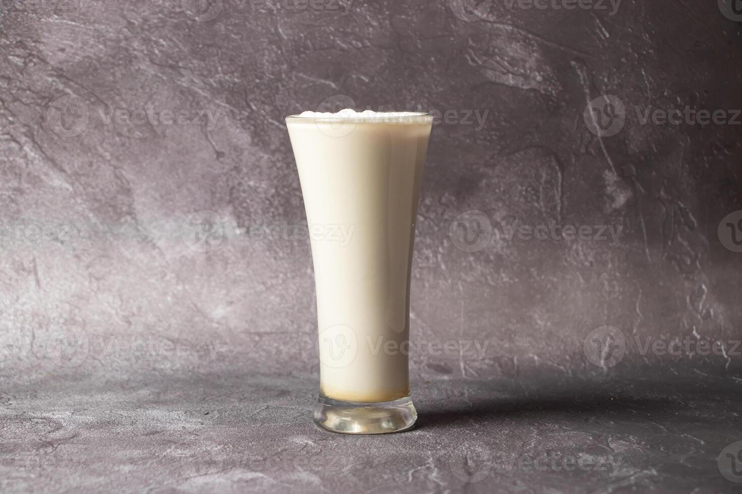 Fresh Lassi or Lachi served in glass isolated on background top view of bangladesh, india and Pakistan drink photo