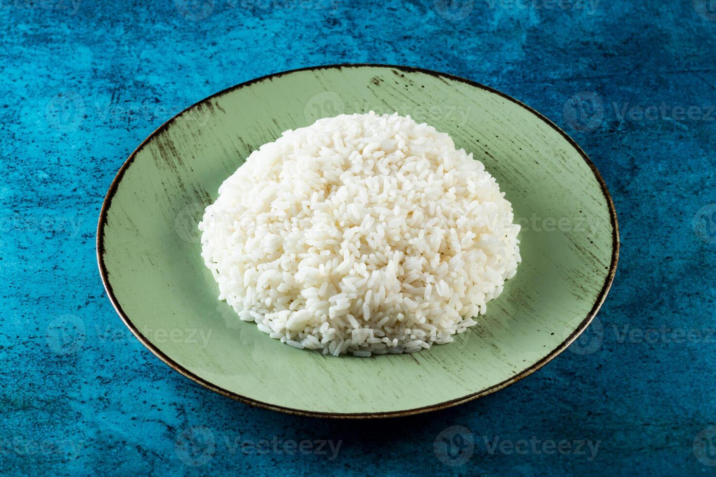 Plain boiled rice in a plate top view on marble background photo