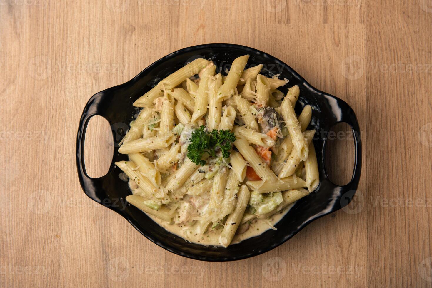 Pasta with white sauce served in dish isolated on table top view of arabian food photo