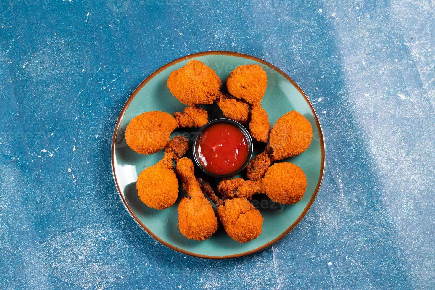 Deep fried Chicken Lolipop or Chicken drumstick with tomato sauce and mayo dip served in a dish isolated on background side view photo