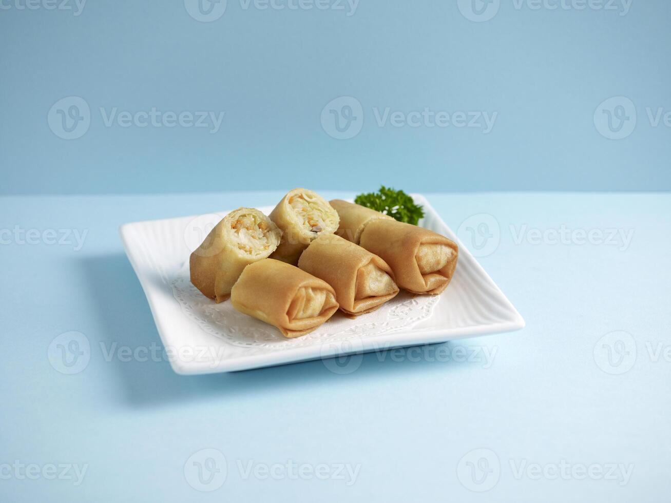 Crispy Vegetable Spring Roll Served in a dish isolated on wooden board side view on grey background photo