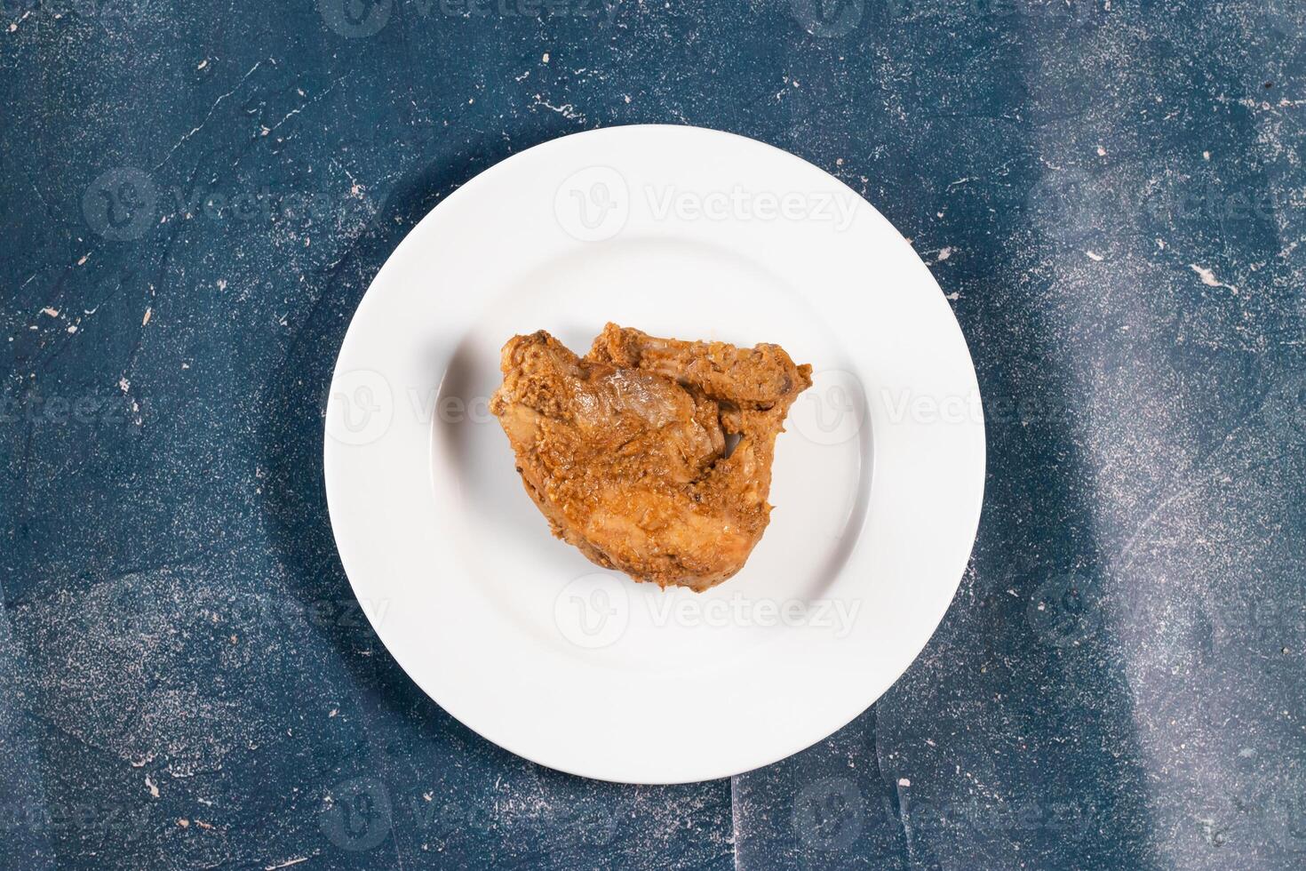 Crispy fried chicken piece in a plate isolated on marble background top view fast food photo