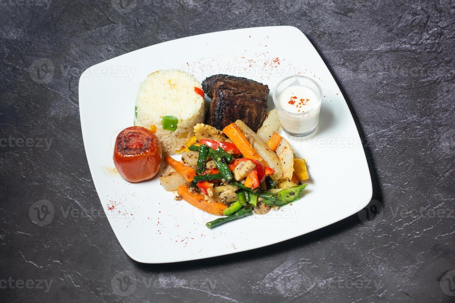 Beef Steak with rice, tomato, salad and dip served in dish isolated on grey background top view of indian and bangladesh food photo