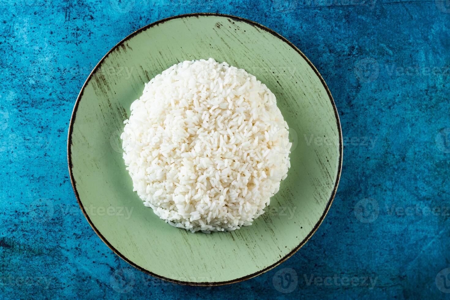 Plain boiled rice in a plate top view on marble background photo