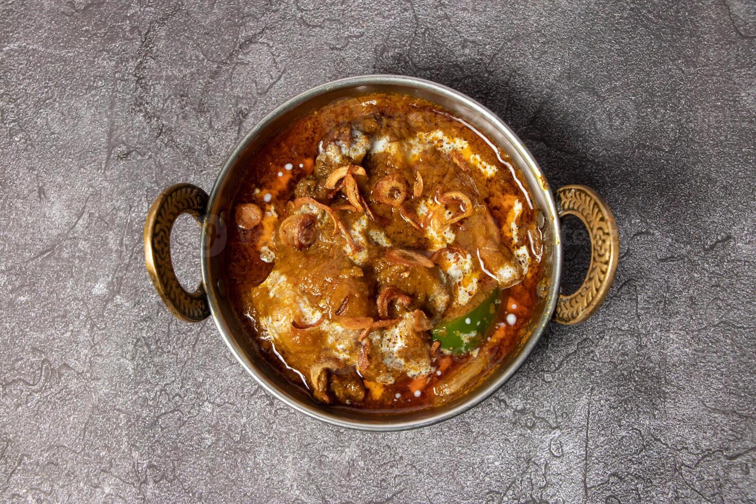 Mutton karahi, vindaloo, rogan josh, bhuna, korma masala gravy served in dish isolated on background top view of bangladesh food photo