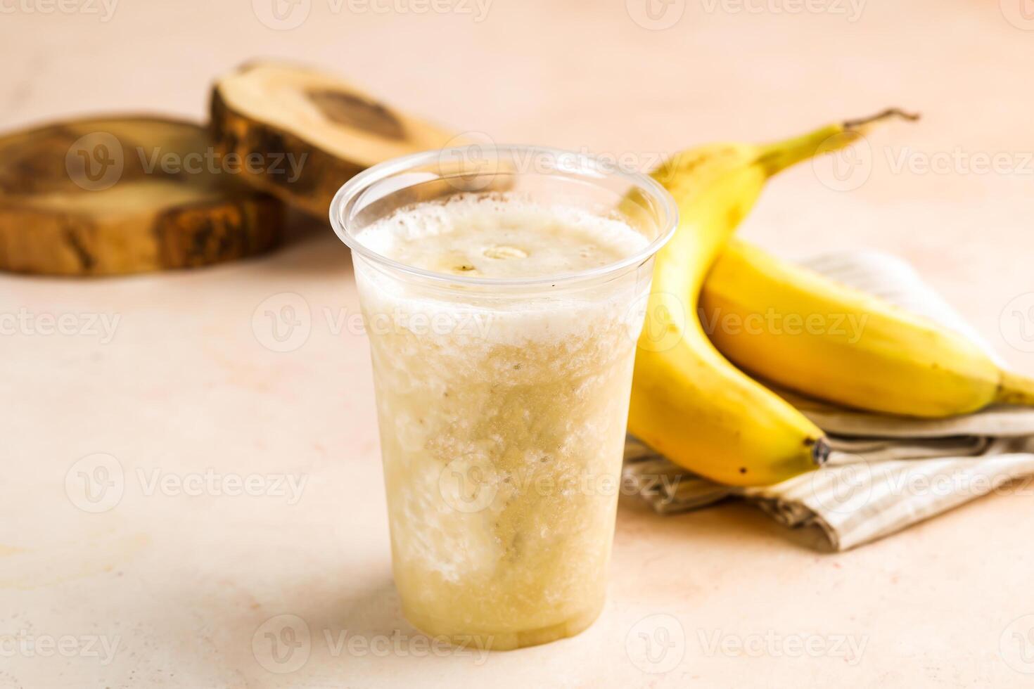 Fresh Banana Juice with raw fruit served in glass isolated on table top view healthy morning drink photo