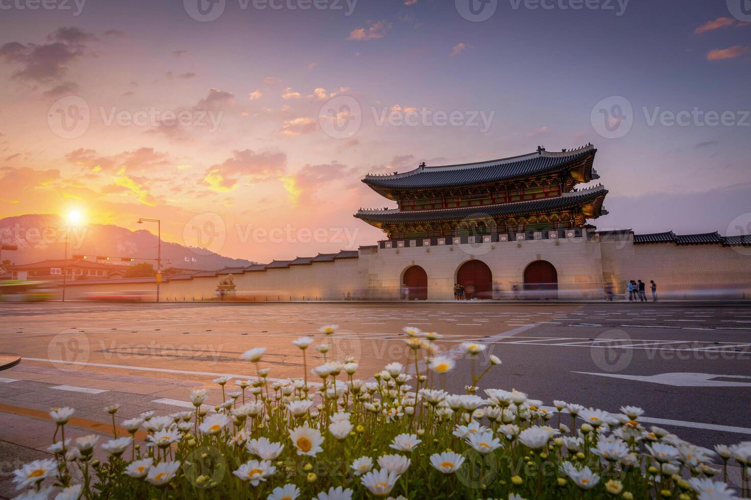 Gyeongbokgung Palace, Cars passing in front of Gwanghuamun gate in sunset in downtown Seoul, South Korea. Name of the Palace 'Gyeongbokgung' photo