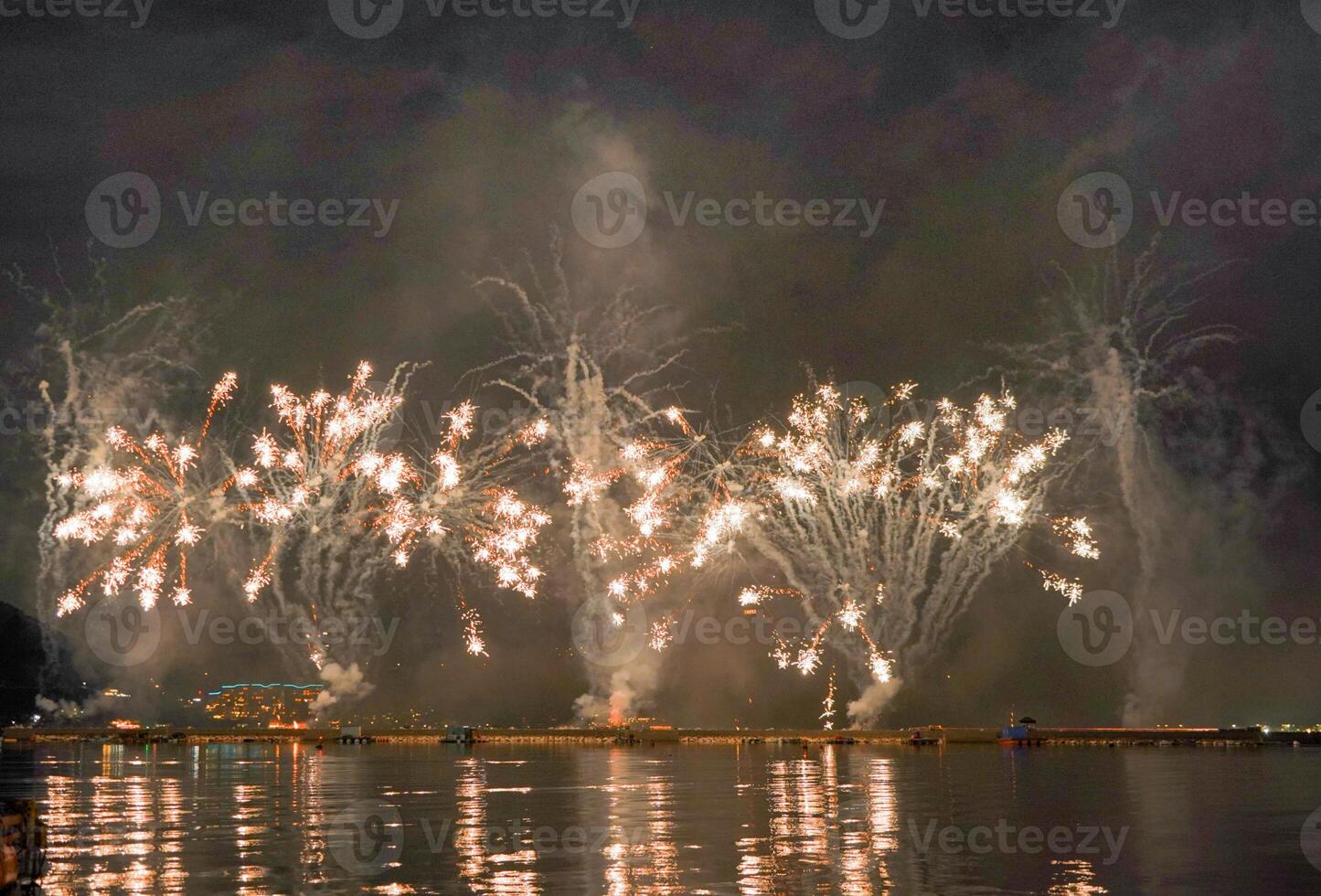 A colorful fire works during a celebration in the river with beautiful reflection in the water photo
