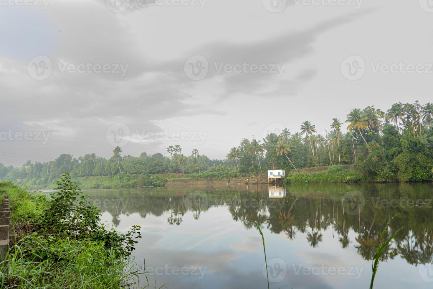 A beutiful scenery of landscape with river, sky in village in kerala, india photo