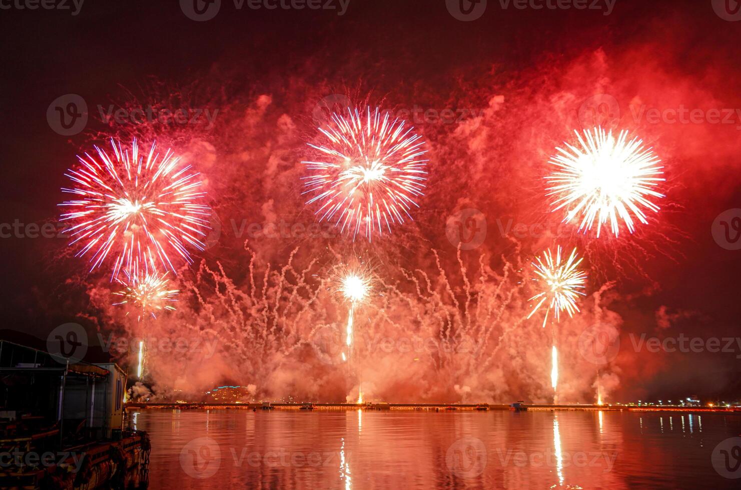 A colorful fire works during a celebration in the river with beautiful reflection in the water photo