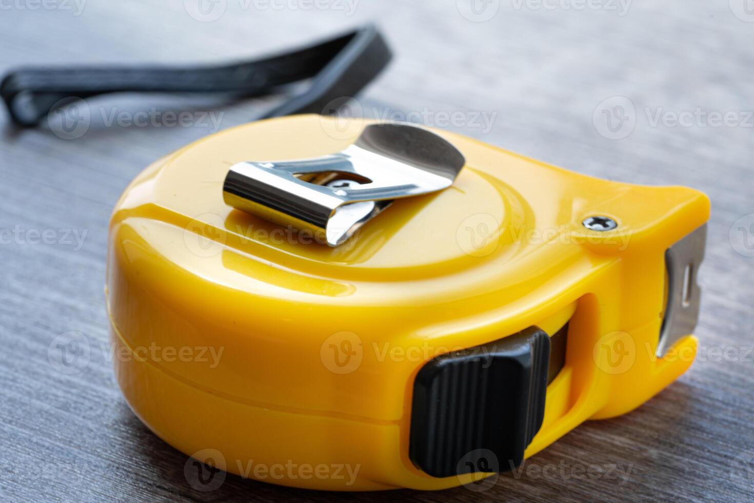 steel metal maesuring tape yelow color macro in a table photo