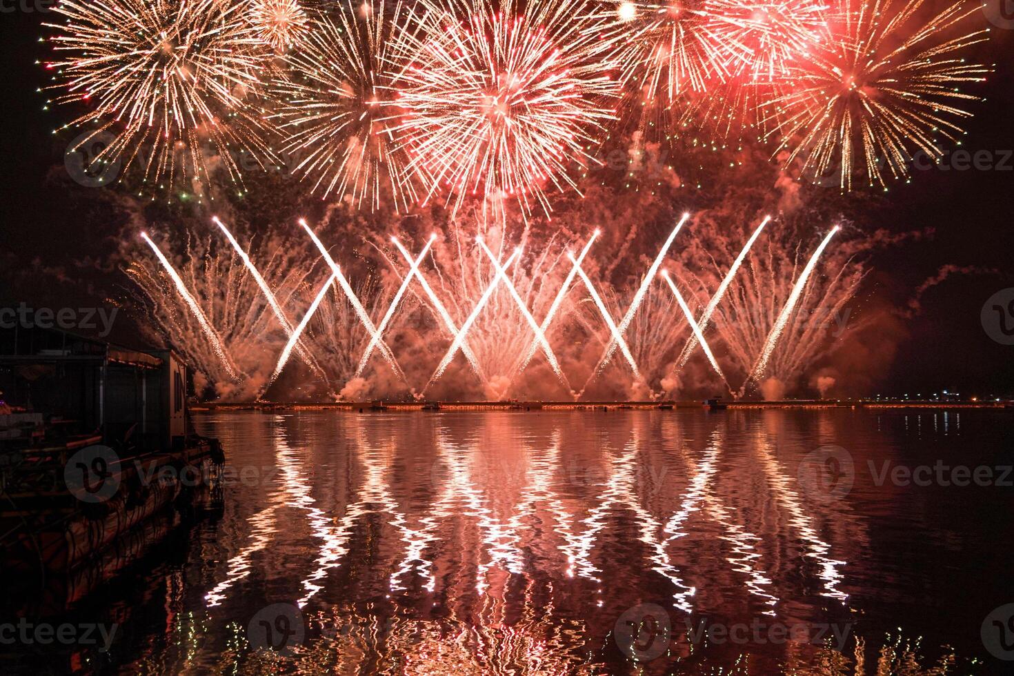 A colorful fire works during a celebration in the river with beautiful reflection in the water photo