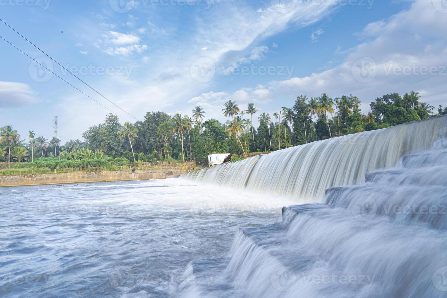 A beautiful view of a waterfall from a check dam In Kerala, India. photo