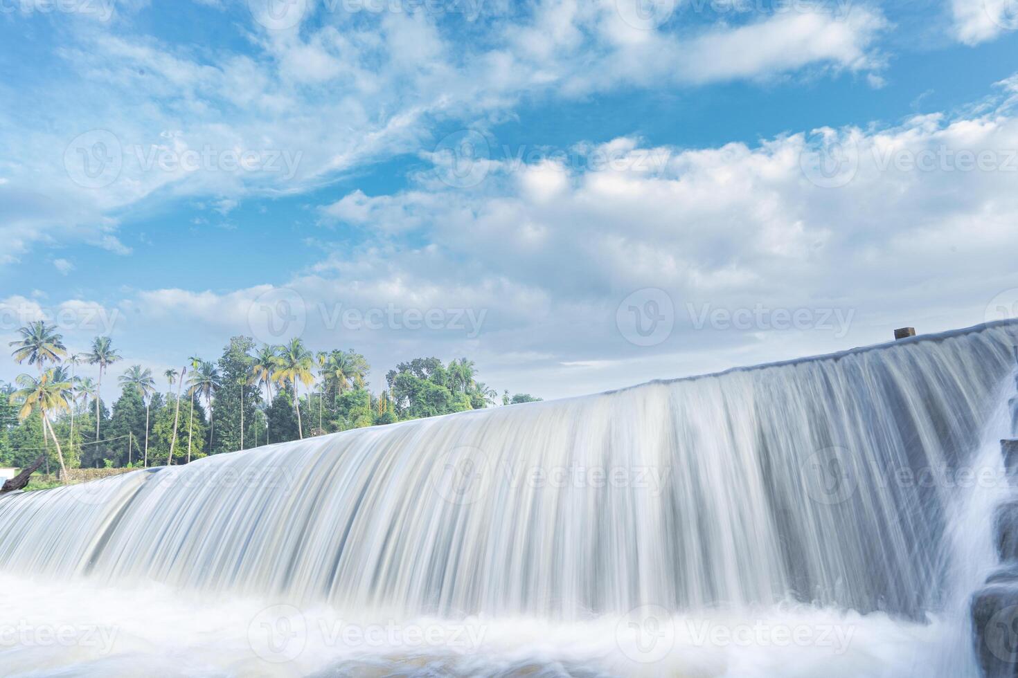 A beautiful view of a waterfall from a check dam In Kerala, India. photo