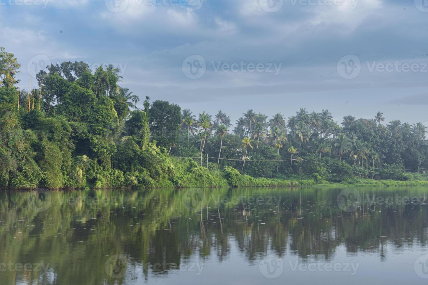 A beutiful scenery of landscape with river, sky in village in kerala, india photo