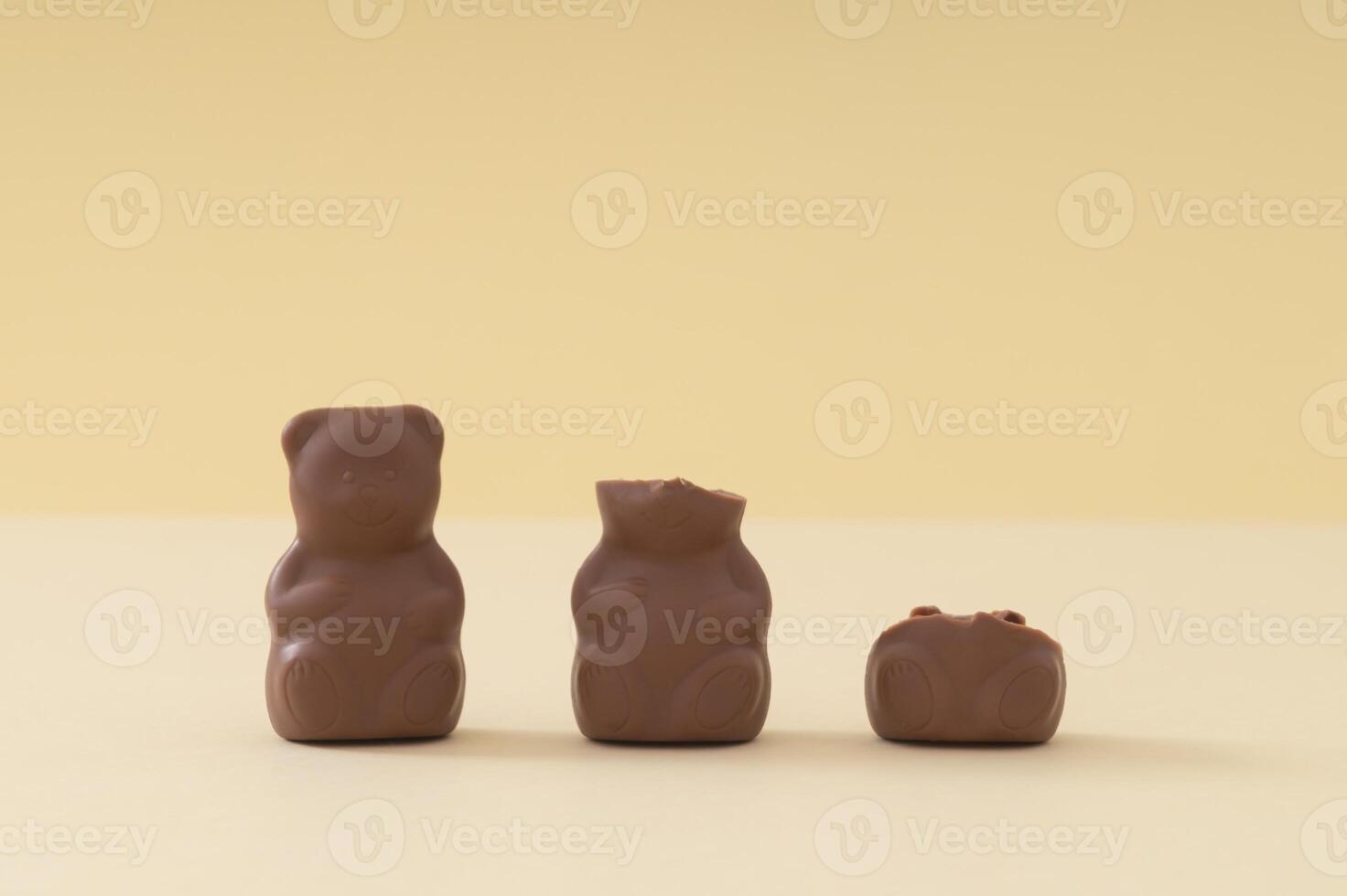 Creative arrangement made with chocolate teddy bears on pastel cream background. Creative sweet food concept. Yummy chocolate teddy bear idea. Minimal style. Chocolate aesthetic. photo