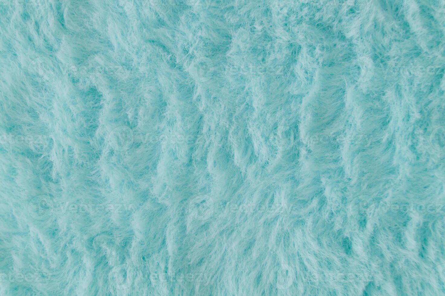 Light blue faux fur background. Close up surface wool texture. Minimal background concept. Trendy color luxury layout. Fluffy fur flat lay. Retro fashion aesthetic idea. Copy space. photo