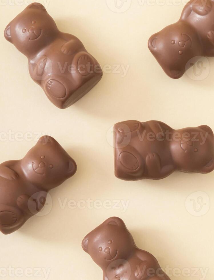 Trendy pattern composition made with chocolate teddy bears on pastel cream background. Creative sweet food concept. Yummy chocolate teddy bear idea. Minimal style. Chocolate aesthetic. photo