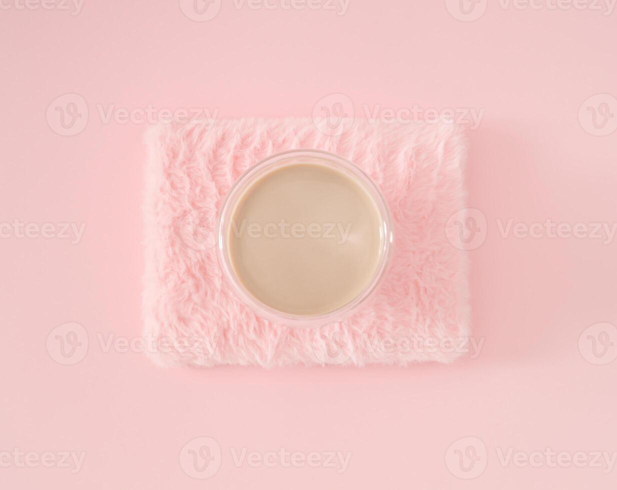 Trendy arrangement of cup of coffee on light pastel pink faux fur background. Minimal coffee concept. Creative fancy coffee idea. Pink flat lay composition. photo
