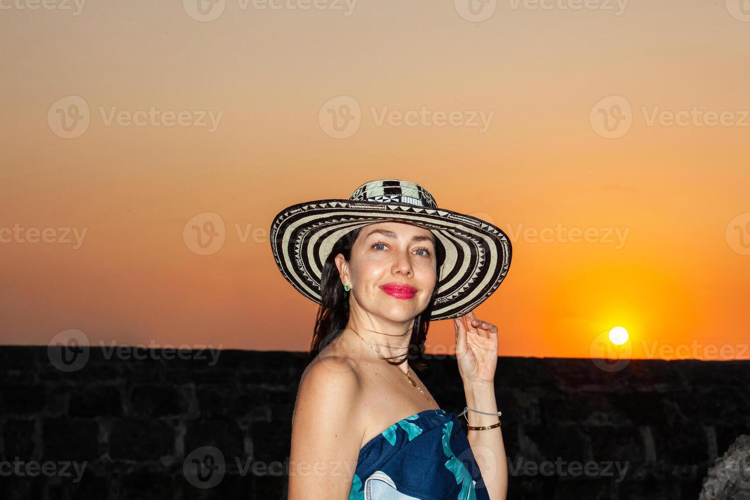 Beautiful woman wearing the traditional Colombian hat called Sombrero Vueltiao at the historical streets of the Cartagena de Indias walled city photo