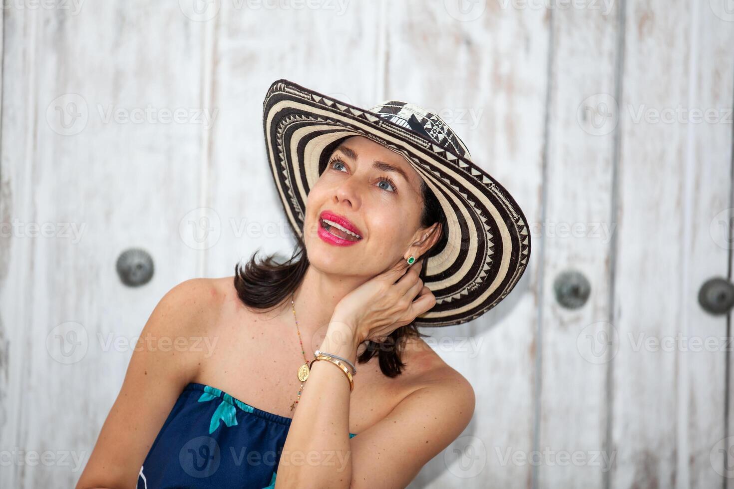 Beautiful woman wearing the traditional Colombian hat called Sombrero Vueltiao at the historical streets of the Cartagena de Indias walled city photo