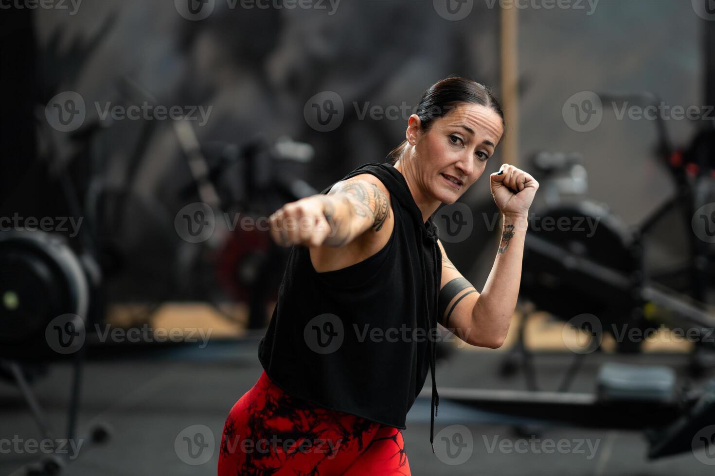 Expertise female fighter training in the gym photo