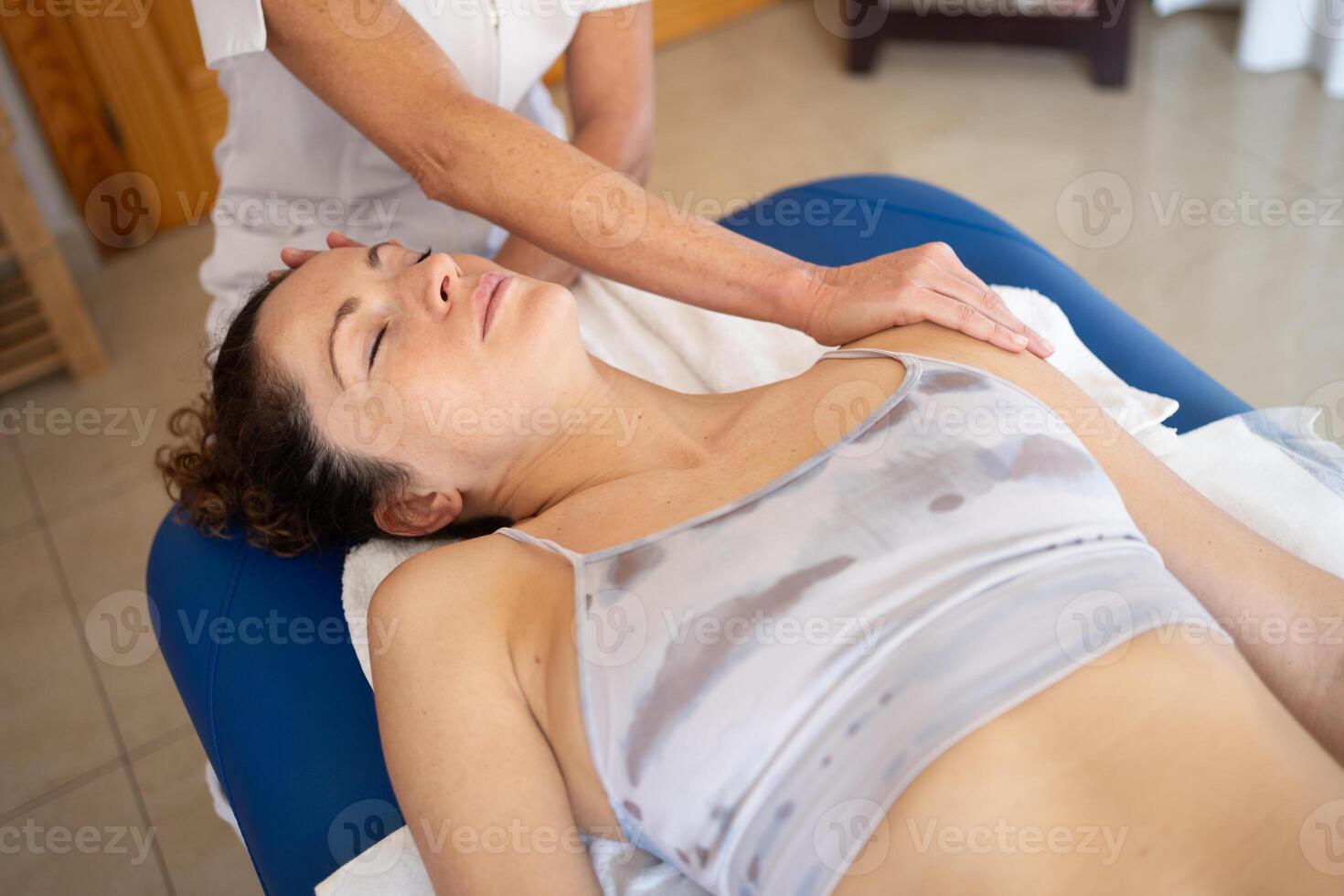 Crop osteopath treating patient during appointment photo