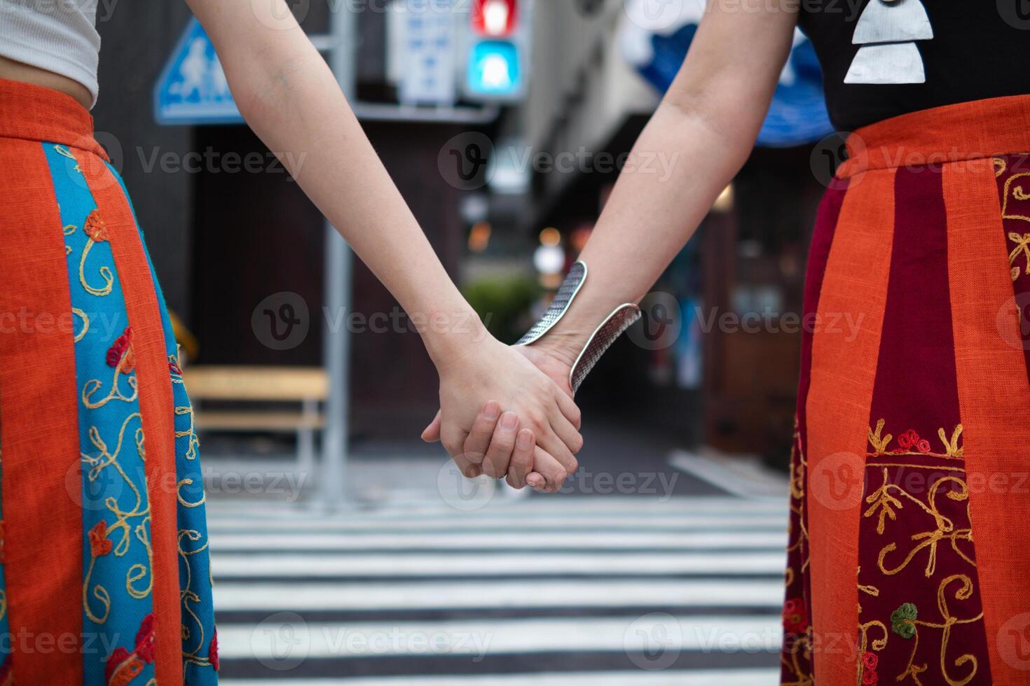 lgbtq couples openly walk hand in hand down street to show lgbtq rights and freedoms of love for each other. lgbtq couples walk hand in hand down street show their love and friendship for each other photo