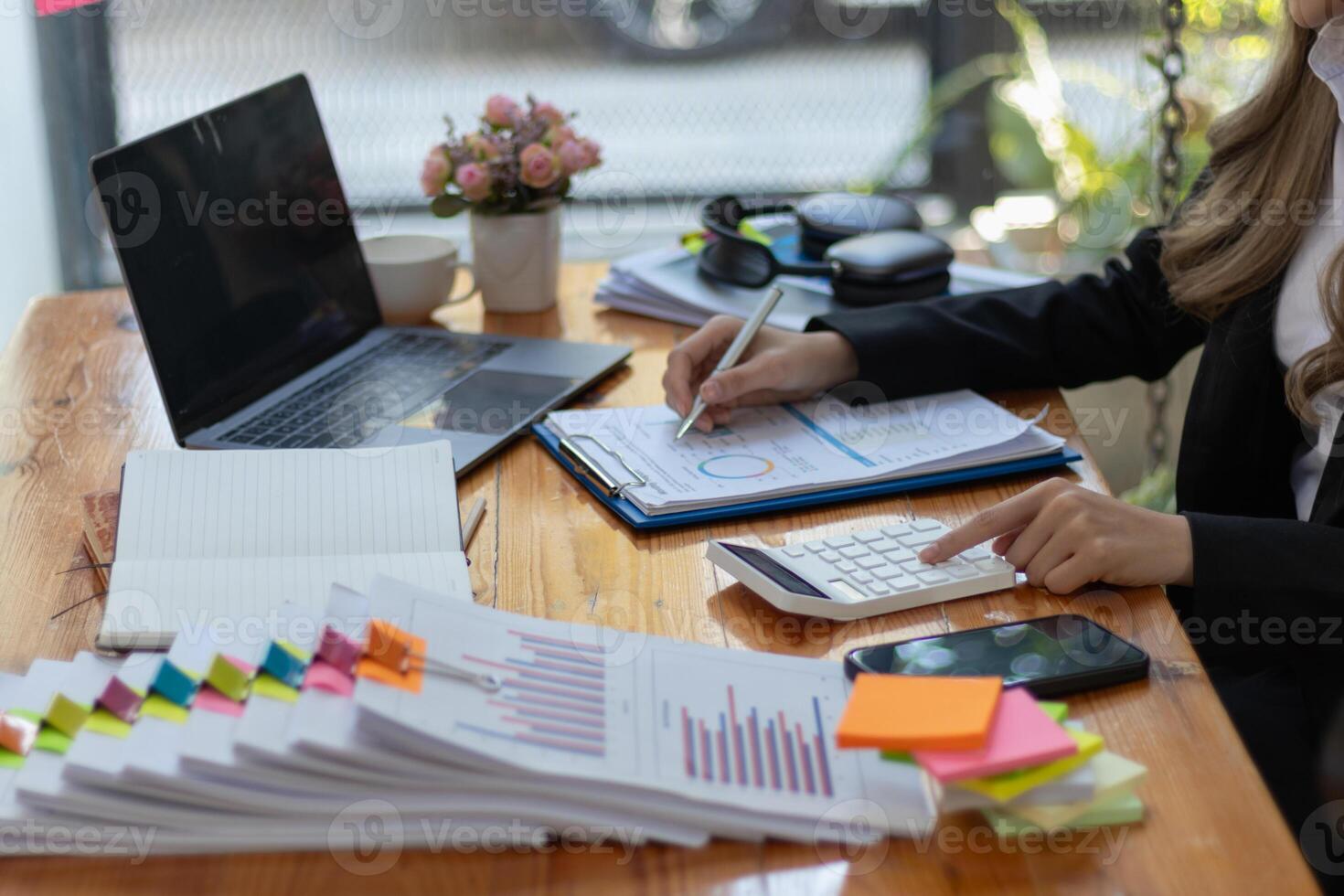 The pile of documents on the secretary's desk was prepared for the executives who would be attending the meeting. Several documents were stacked on the secretary's desk ready for the attendees. photo