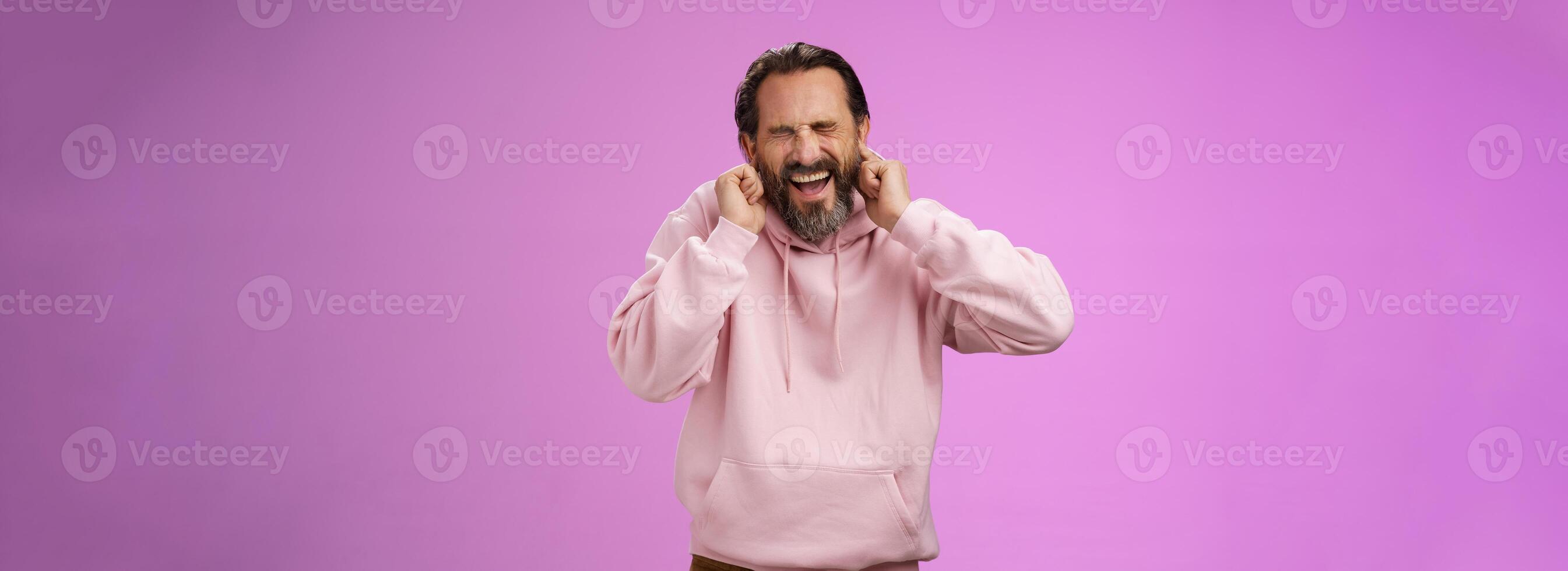 Annoyed fed up pressured caucasian adult man bearded yelling pissed close eyes cringing disgust annoyance close ears bothered cannot stand loud awful noise, grimacing shouting turn off music photo