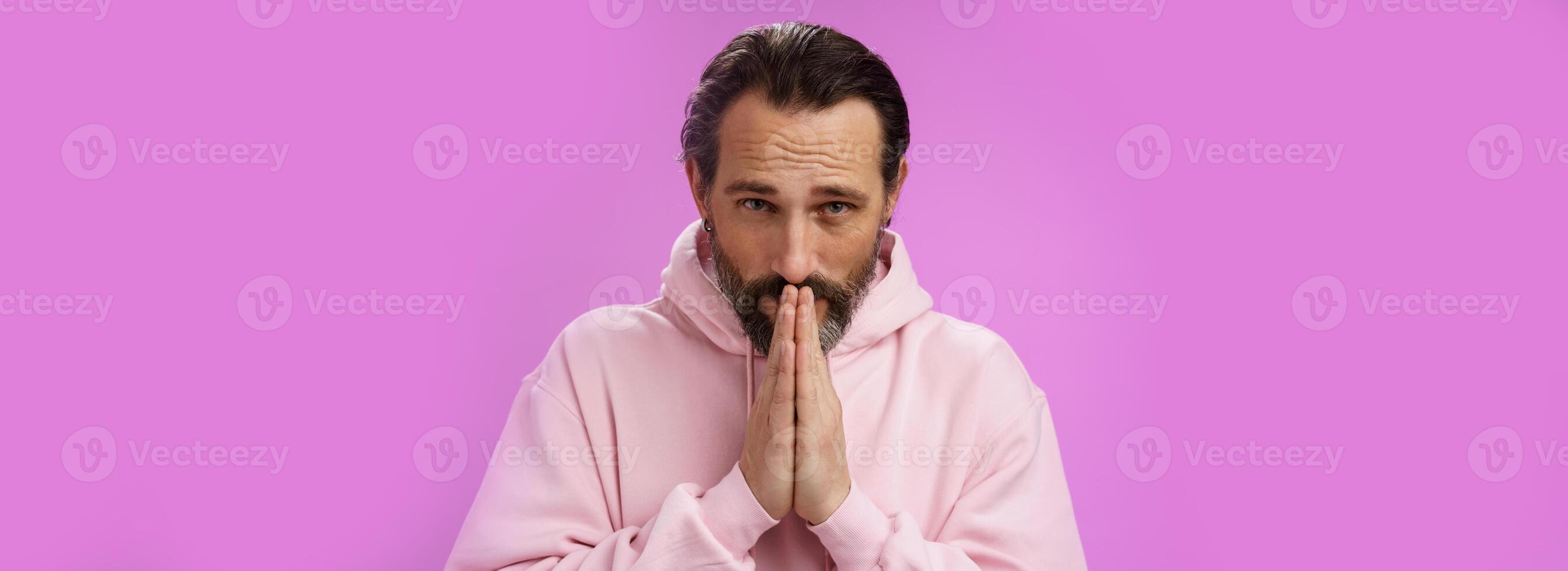 Worried intense serious-looking troubled handsome mature bearded man praying waiting important news nervously looking camera press palms supplicating wish wife alright, standing purple background photo